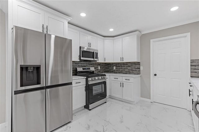 kitchen with recessed lighting, white cabinetry, appliances with stainless steel finishes, and backsplash