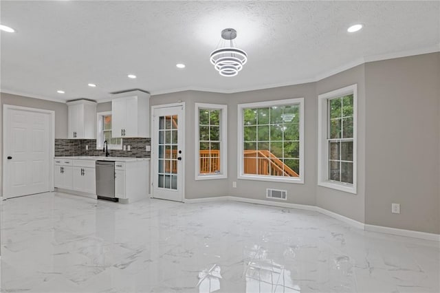 kitchen with crown molding, marble finish floor, dishwasher, and visible vents