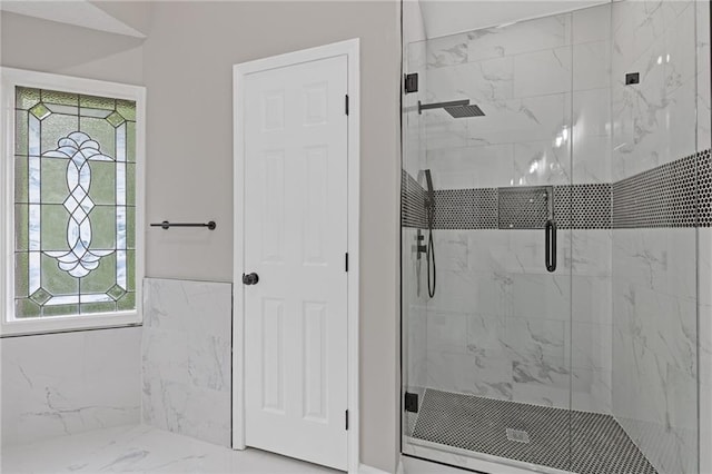 full bathroom featuring a stall shower and marble finish floor