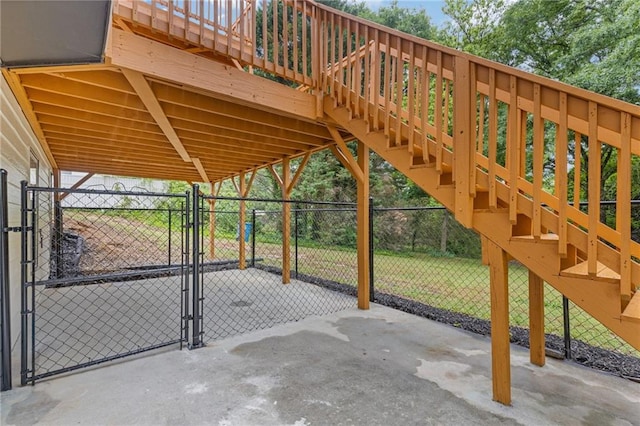 view of patio / terrace featuring stairway, fence, and a gate