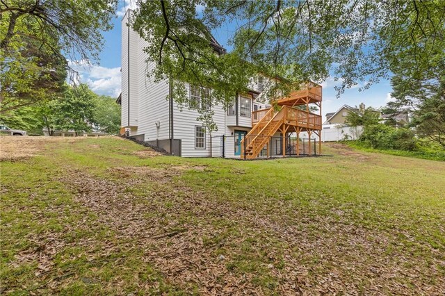 rear view of property with stairs, a lawn, a wooden deck, and a chimney