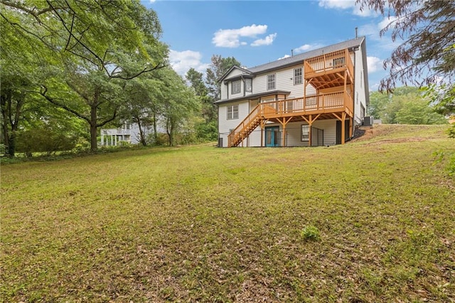 back of property featuring a yard, a deck, and stairs