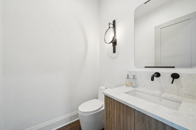 71 Krog St NE, Atlanta, GA 30307 - half bathroom featuring vanity, toilet, wood finished floors, and baseboards