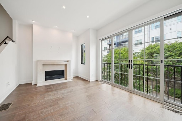 71 Krog St NE, Atlanta, GA 30307 - unfurnished living room featuring baseboards, a fireplace with flush hearth, recessed lighting, and wood finished floors