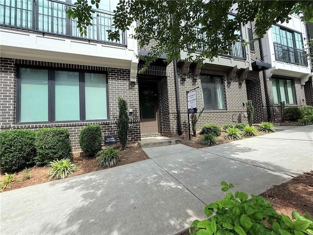 71 Krog St NE, Atlanta, GA 30307 - property entrance with brick siding and a balcony