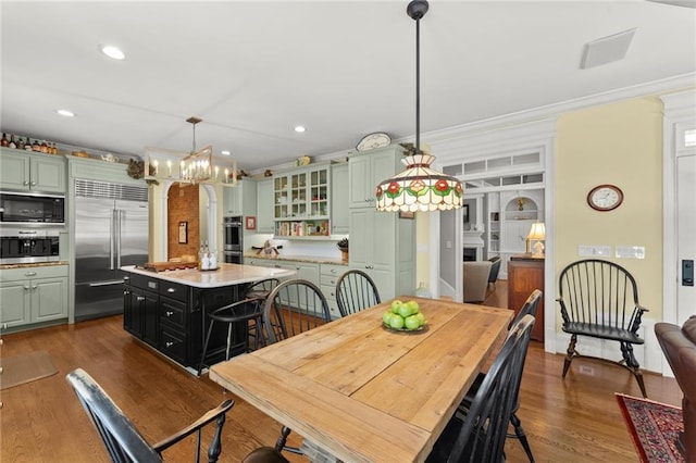 dining area with ornamental molding, recessed lighting, a chandelier, and dark wood-style floors