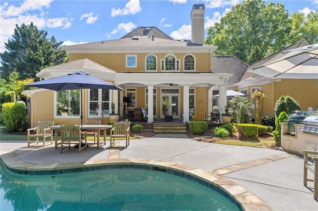 back of house with an outdoor pool, french doors, a patio area, and stucco siding
