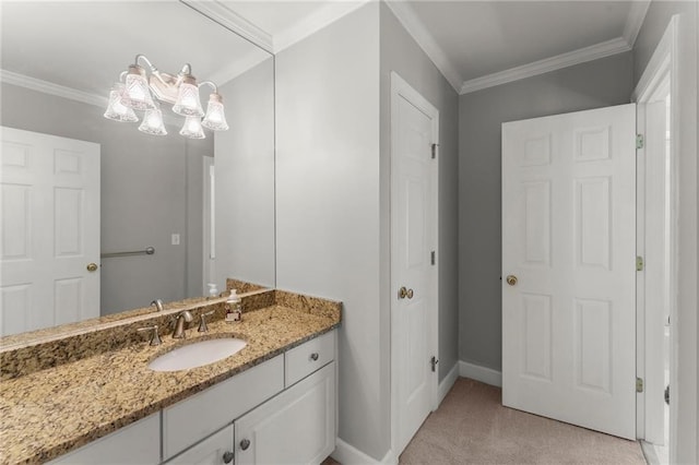 bathroom featuring crown molding, vanity, and baseboards