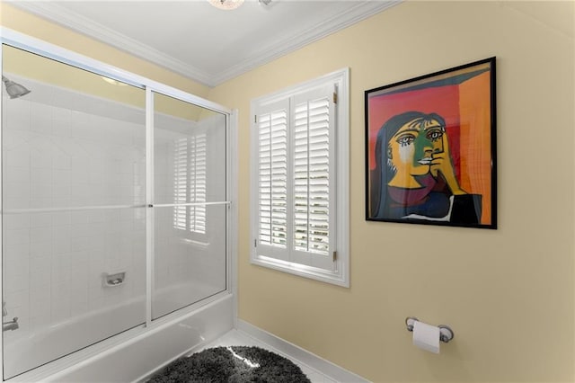 full bath with plenty of natural light, baseboards, ornamental molding, and bath / shower combo with glass door