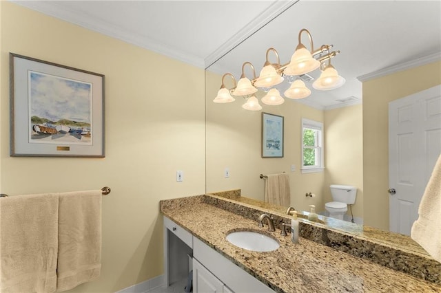 half bathroom with crown molding, toilet, vanity, and baseboards