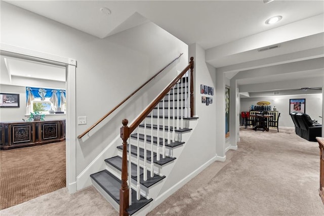 stairway featuring carpet flooring, baseboards, and visible vents