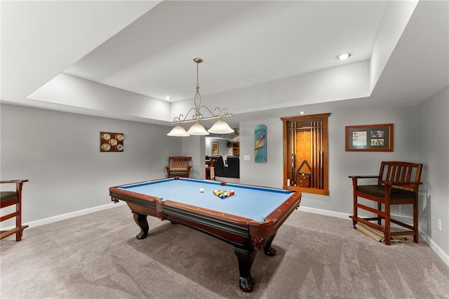 rec room featuring carpet, a tray ceiling, and baseboards