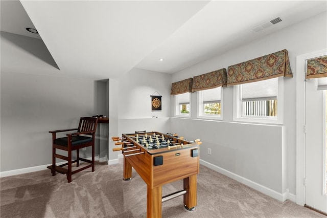 recreation room featuring carpet, visible vents, and baseboards