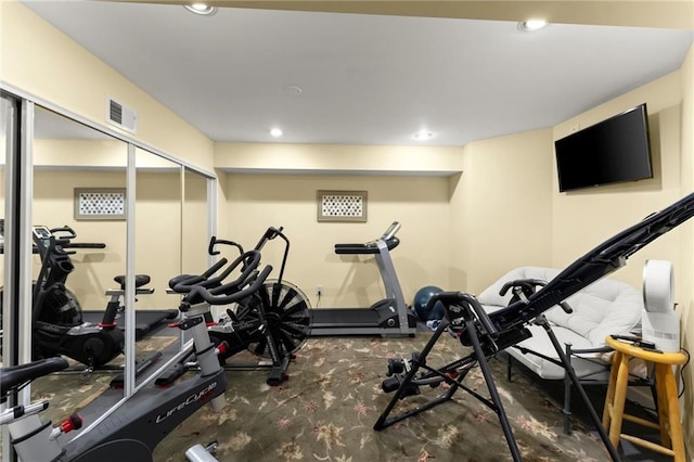 exercise room with carpet flooring, visible vents, and recessed lighting