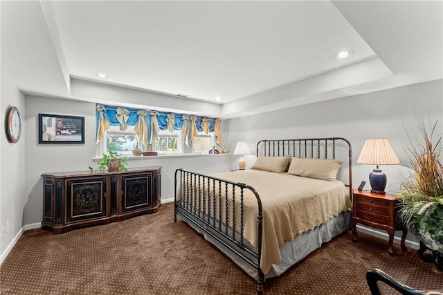 carpeted bedroom featuring recessed lighting, a tray ceiling, and baseboards