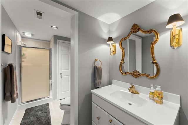 full bathroom featuring vanity, visible vents, toilet, a stall shower, and baseboards
