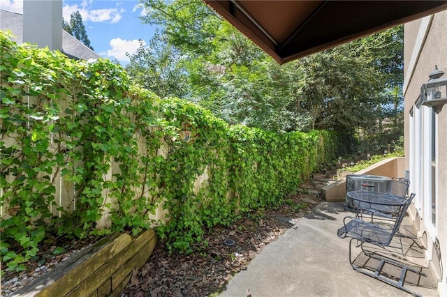 view of patio / terrace with outdoor dining space and central AC unit