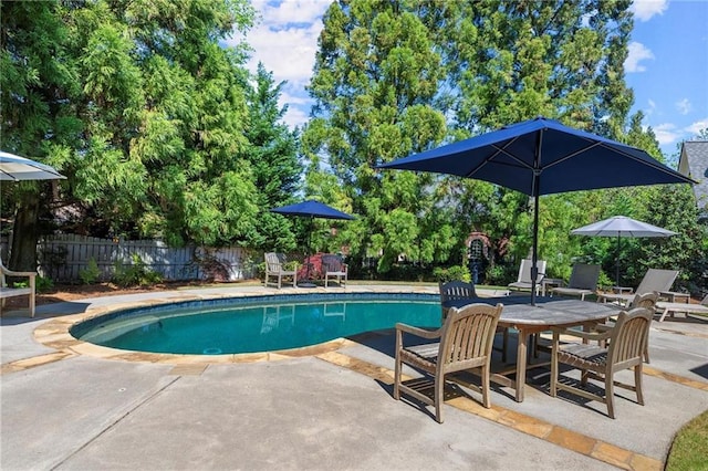 view of pool with a fenced in pool, a patio area, and fence
