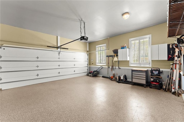 garage featuring wainscoting and a garage door opener