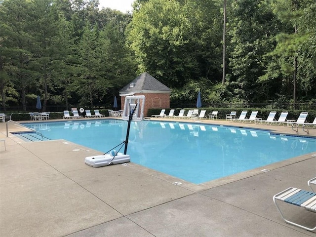 pool featuring a patio area and fence