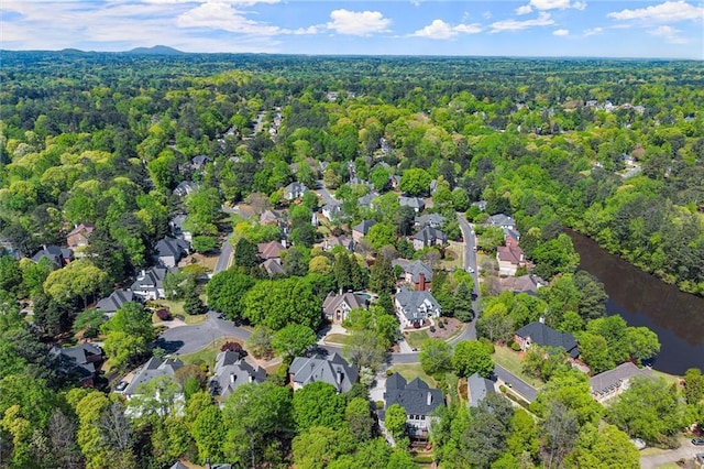 drone / aerial view featuring a view of trees and a residential view
