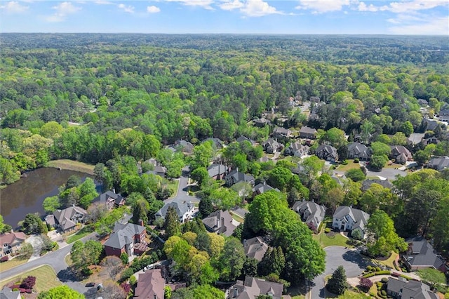 aerial view featuring a water view, a residential view, and a view of trees