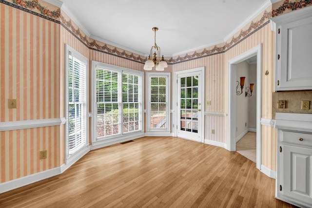 3171 Blairhill Ct, Atlanta, GA 30340 - unfurnished dining area featuring light wood finished floors, a notable chandelier, crown molding, visible vents, and wallpapered walls