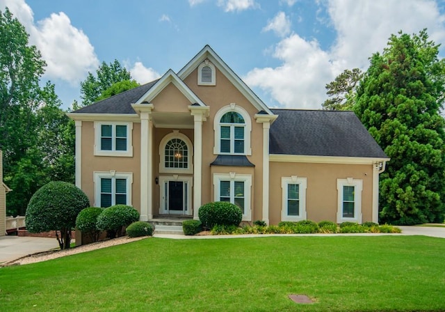 2521 Wood Creek Ct, Dacula, GA 30019 - greek revival inspired property with stucco siding, a front lawn, and a shingled roof