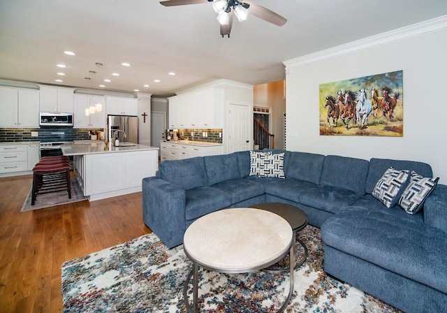 2521 Wood Creek Ct, Dacula, GA 30019 - living room featuring ornamental molding, a ceiling fan, recessed lighting, wood-type flooring, and stairs