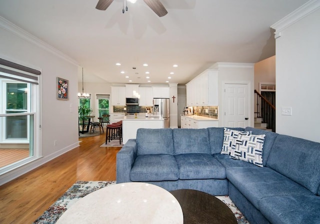 2521 Wood Creek Ct, Dacula, GA 30019 - living room with light wood-style flooring, ornamental molding, recessed lighting, stairs, and a ceiling fan