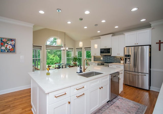 2521 Wood Creek Ct, Dacula, GA 30019 - kitchen featuring appliances with stainless steel finishes, light wood-style flooring, backsplash, light countertops, and recessed lighting