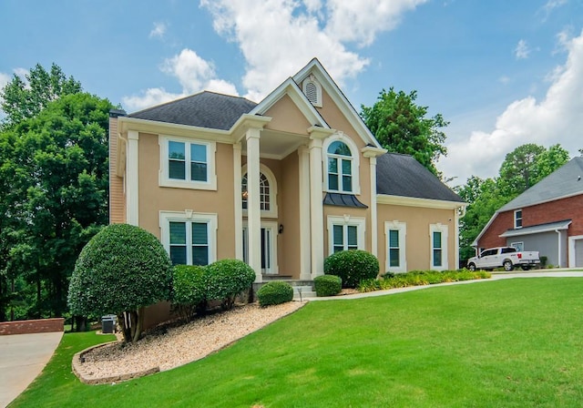 2521 Wood Creek Ct, Dacula, GA 30019 - neoclassical / greek revival house with stucco siding, a front lawn, a standing seam roof, and a metal roof