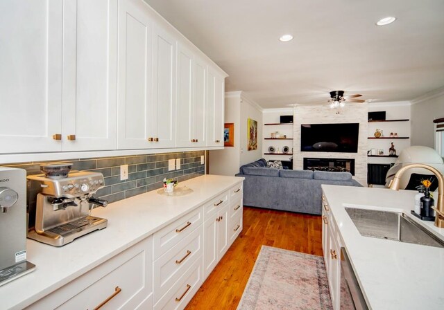 2521 Wood Creek Ct, Dacula, GA 30019 - kitchen featuring a ceiling fan, crown molding, white cabinets, open floor plan, and tasteful backsplash
