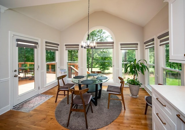 2521 Wood Creek Ct, Dacula, GA 30019 - dining space featuring lofted ceiling, a chandelier, and light wood finished floors