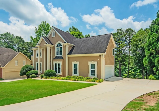 2521 Wood Creek Ct, Dacula, GA 30019 - view of front of home with concrete driveway, stucco siding, a front yard, and an attached garage