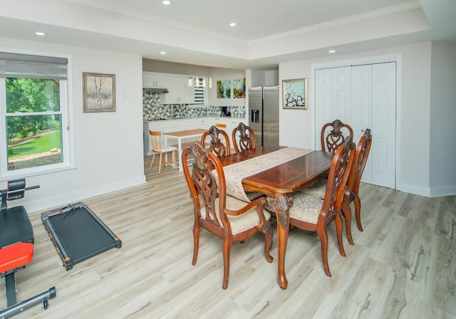 2521 Wood Creek Ct, Dacula, GA 30019 - dining room featuring crown molding, light wood-style flooring, recessed lighting, and a tray ceiling