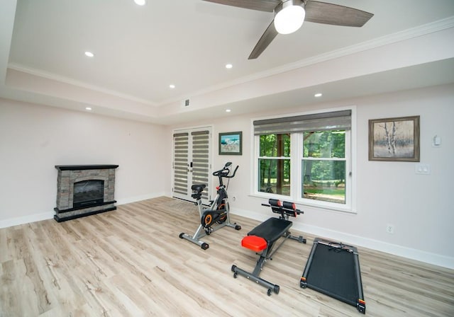 2521 Wood Creek Ct, Dacula, GA 30019 - workout room with ornamental molding, wood finished floors, recessed lighting, a ceiling fan, and a stone fireplace