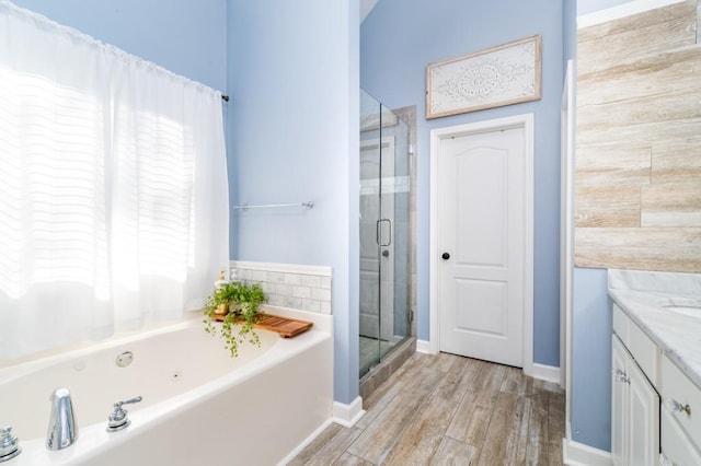 bathroom featuring wood-type flooring, vanity, and plus walk in shower