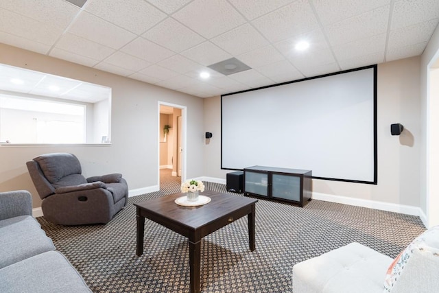 home theater room featuring carpet and a drop ceiling