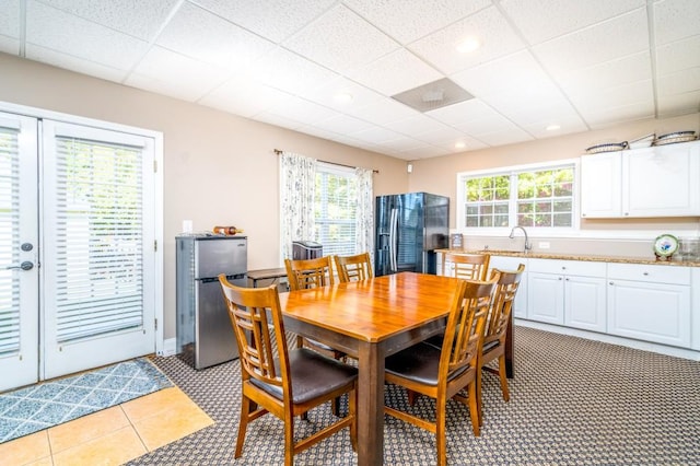 dining room featuring a paneled ceiling and sink