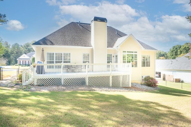 back of house featuring a deck and a yard