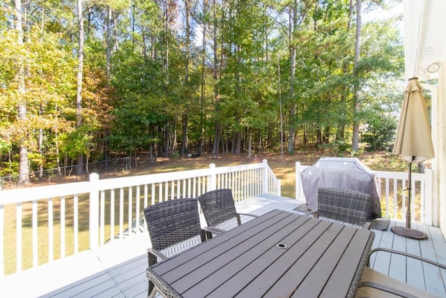 wooden terrace featuring a grill