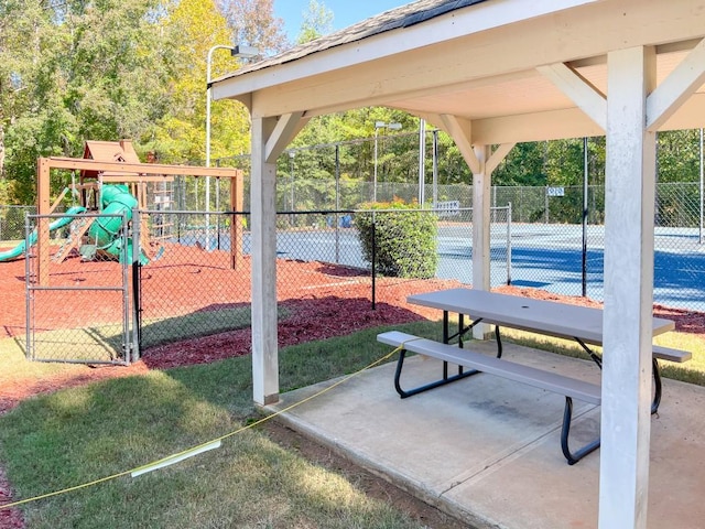 view of property's community featuring a playground and tennis court