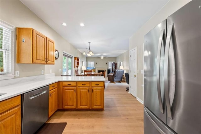 3652 Morning Creek Ct, Suwanee, GA 30024 - kitchen featuring stainless steel appliances, light wood-type flooring, light countertops, a chandelier, and a peninsula