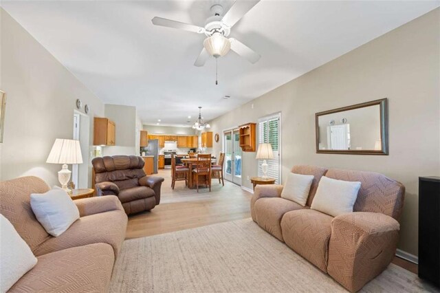 3652 Morning Creek Ct, Suwanee, GA 30024 - living area with light wood finished floors, ceiling fan, a chandelier, and recessed lighting
