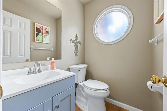 3652 Morning Creek Ct, Suwanee, GA 30024 - half bath featuring toilet, vanity, wood finished floors, and baseboards