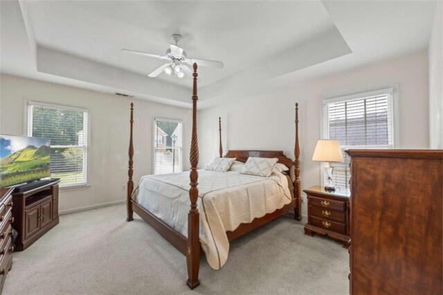 3652 Morning Creek Ct, Suwanee, GA 30024 - bedroom with a tray ceiling, multiple windows, baseboards, and light carpet
