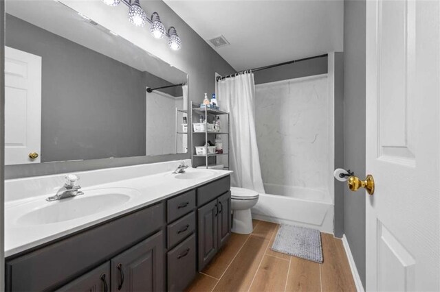 3652 Morning Creek Ct, Suwanee, GA 30024 - bathroom with wood finished floors, shower / bath combination with curtain, double vanity, and toilet