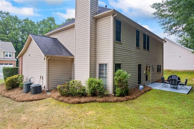 3652 Morning Creek Ct, Suwanee, GA 30024 - back of property with a chimney, a patio area, a yard, and central AC