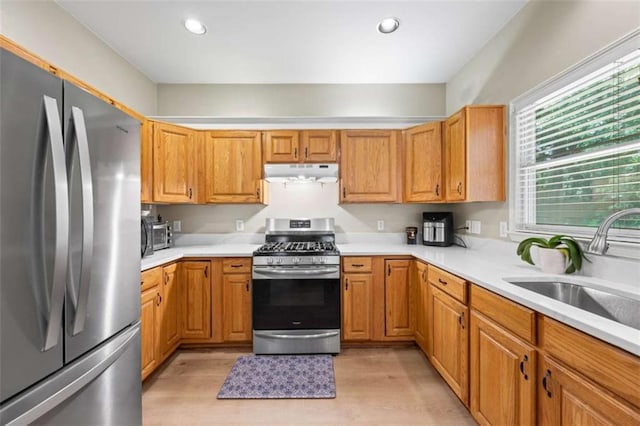 3652 Morning Creek Ct, Suwanee, GA 30024 - kitchen with appliances with stainless steel finishes, under cabinet range hood, light countertops, light wood-style flooring, and recessed lighting